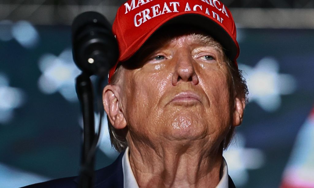 Donald Trump, pictured in a red hat.