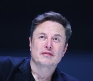 Elon Musk wearing a suit at a panel