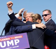 Donald Trump being saved by secret service after shots rang out at his campaign rally by shooter Thomas Matthew Crooks