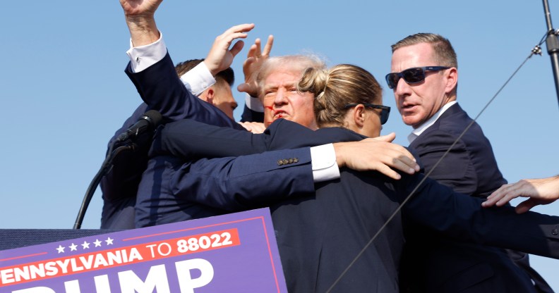 Donald Trump being saved by secret service after shots rang out at his campaign rally by shooter Thomas Matthew Crooks