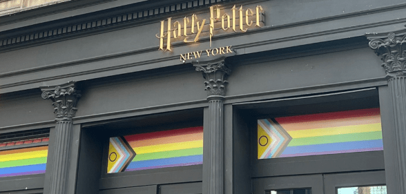 A shopfront bearing the Harry Potter logo and a Progress Pride flag