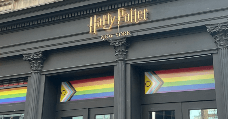 A shopfront bearing the Harry Potter logo and a Progress Pride flag