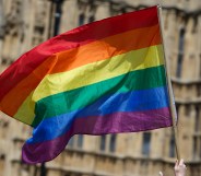 An LGBTQ+ pride flag flying outside parliament