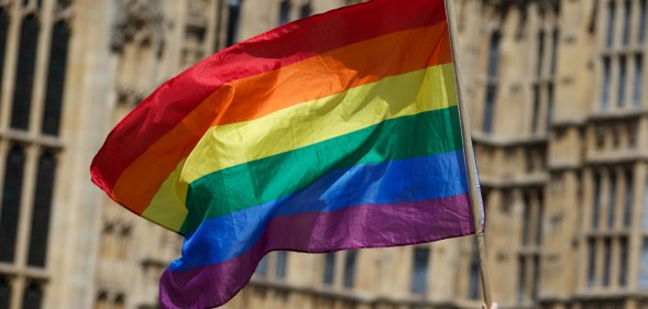 An LGBTQ+ pride flag flying outside parliament