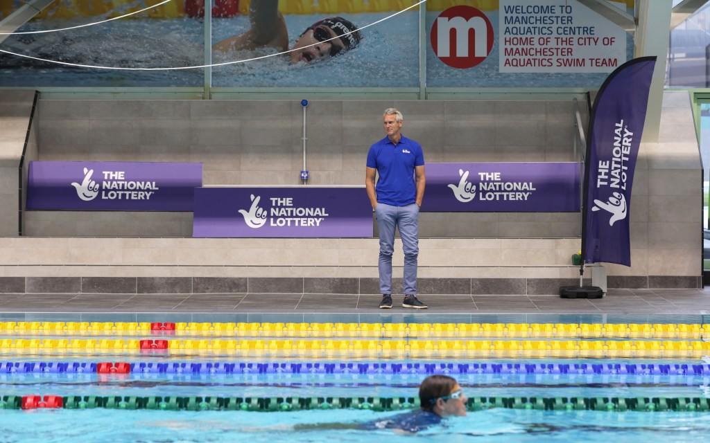 Mark Foster stood by the side of a swimming pool