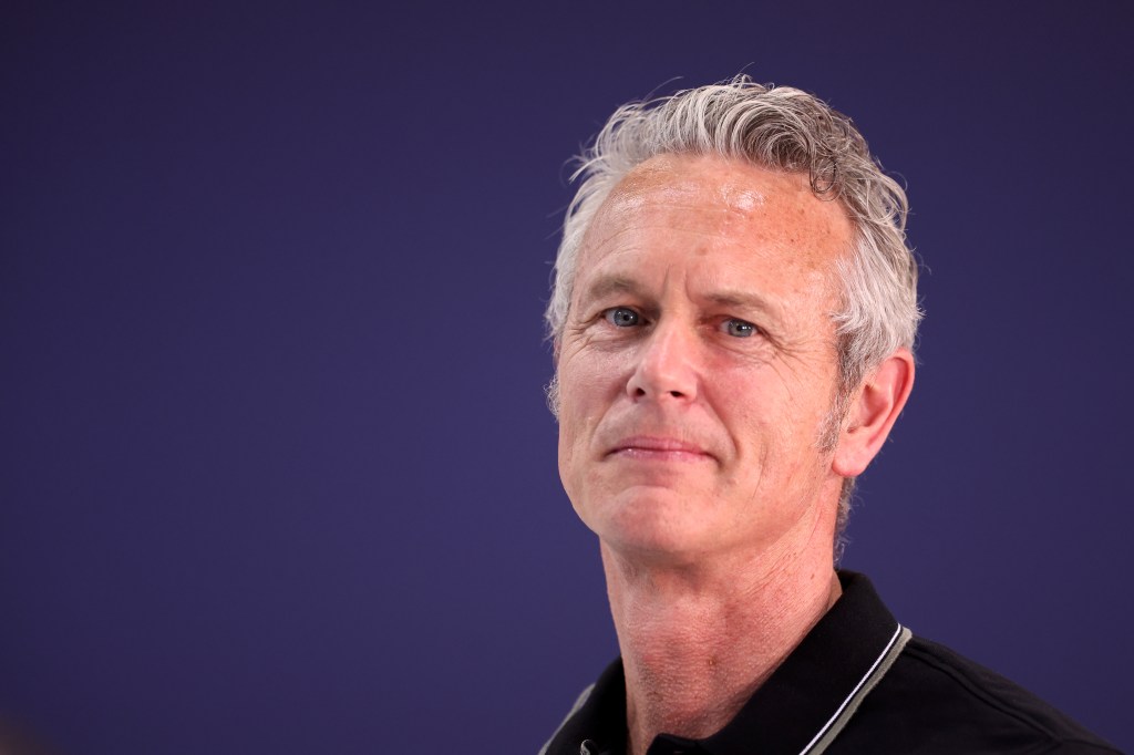 Headshot of Mark Foster against a dark blue background