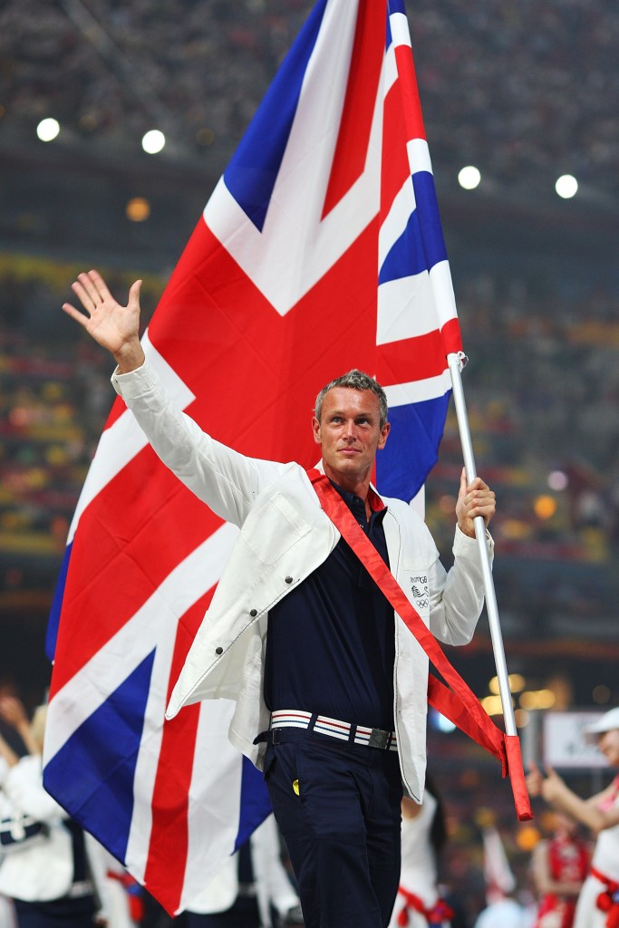 Mark Foster carries the Great Britain flag during the 2008 Beijing Olympics Opening Ceremony.