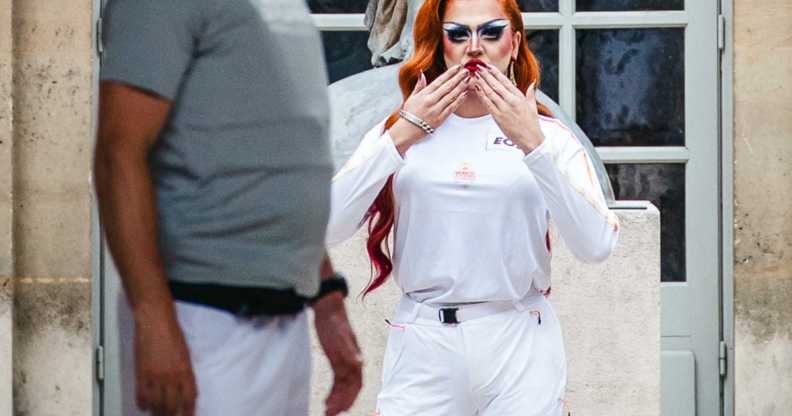 Parisian drag queen Minima Gesté, whose real name is Arthur Raynaud, under the statue of the Victory (sculpture by Louis Simon Boizot), was a torchbearer at the Musee Carnavalet in Maris during the Route of the Olympic torch relay in Paris, France on 14 July, 2024.