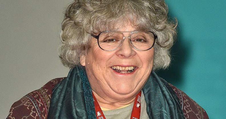 Miriam Margolyes, pictured in a pair of glasses, a scarf, and a brown top.