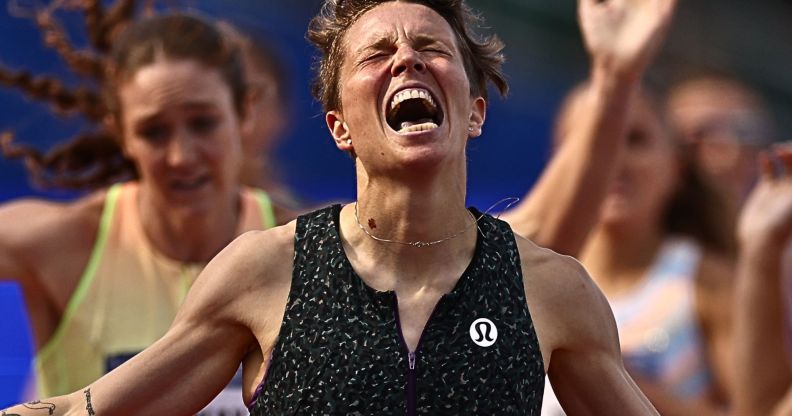 Nikki Hiltz, with their eyes closed, screams in victory after winning the 1500m race.