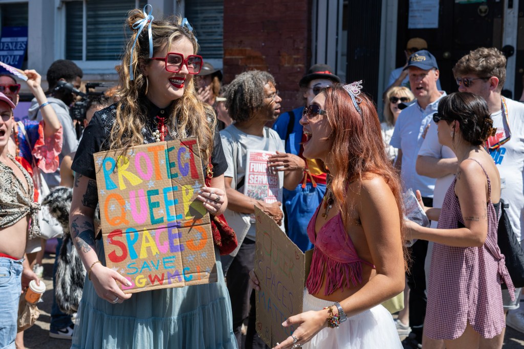 'Protect queer spaces,' a protestors banner reads. 