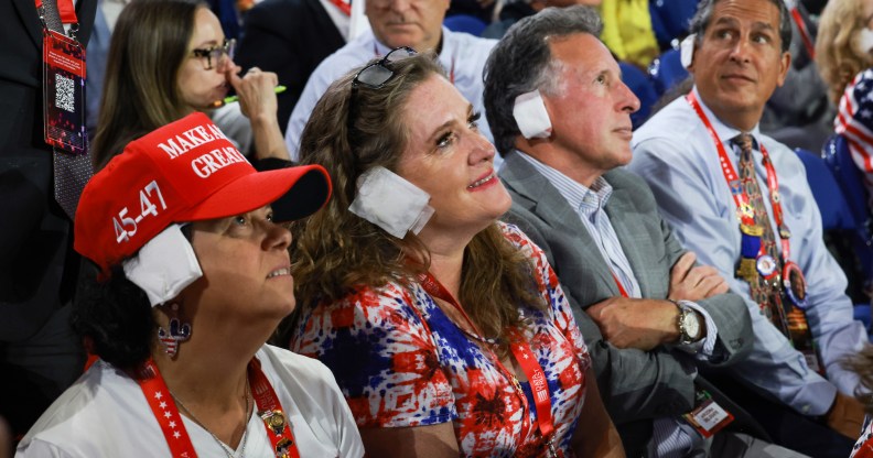 MILWAUKEE, WISCONSIN - JULY 17: People wear "bandages" on their ears as they watch on the third day of the Republican National Convention at the Fiserv Forum on July 17, 2024 in Milwaukee, Wisconsin. Delegates, politicians, and the Republican faithful are in Milwaukee for the annual convention, concluding with former President Donald Trump accepting his party's presidential nomination. The RNC takes place from July 15-18. (Photo by Joe Raedle/Getty Images)