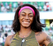 Sha'Carri Richardson possing with a smile after she won her race