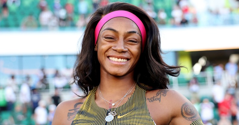 Sha'Carri Richardson possing with a smile after she won her race