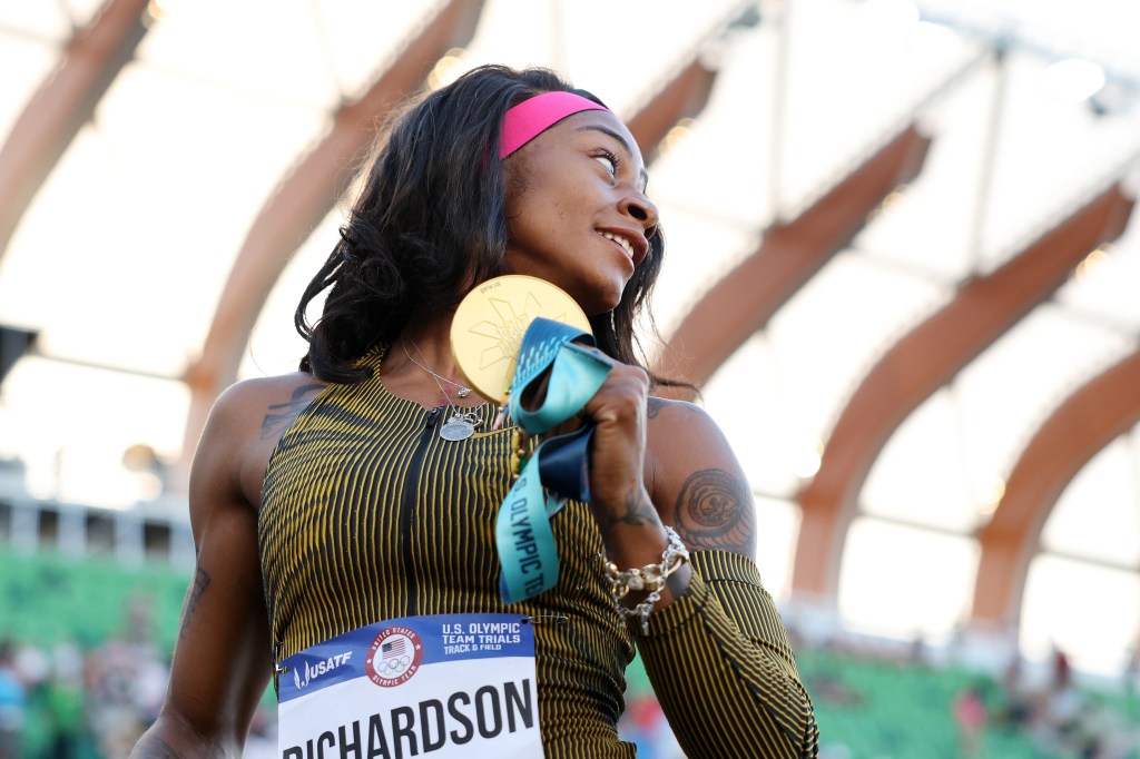 ha'Carri Richardson poses with her gold medal after winning the women's 100 meter final