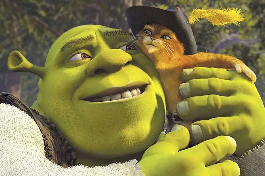 Shrek holding Puss in Boots close to his face in a hug.