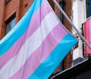 Trans flag in foreground with lesbian flag in background
