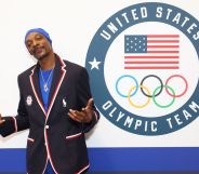 Snoop Dogg standing in front of a sign that says 'United States Olympic Team'
