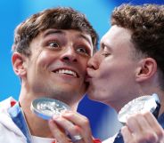 Noah Williams kisses Tom Daley after they won silver at the Paris 2024 Olympics.