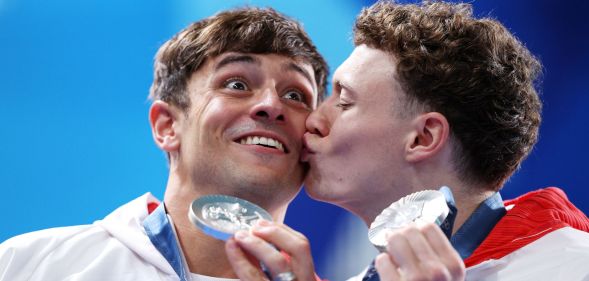 Noah Williams kisses Tom Daley after they won silver at the Paris 2024 Olympics.