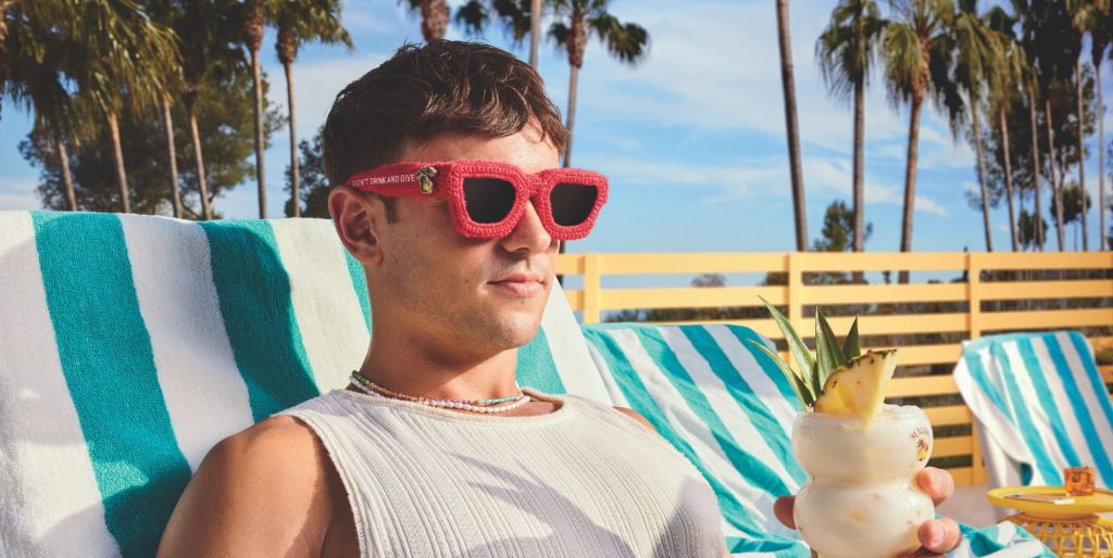 Tom Daley poses in red knitted sunglasses