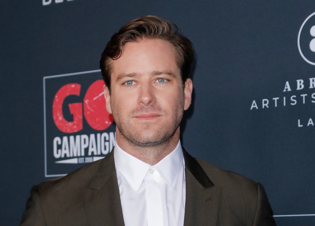 Armie Hammer attends the Go Campaign's 13th Annual Go Gala wearing a white shirt and khaki suit blazer.