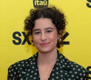 Ilana Glazer in a spotted dress against a yellow background