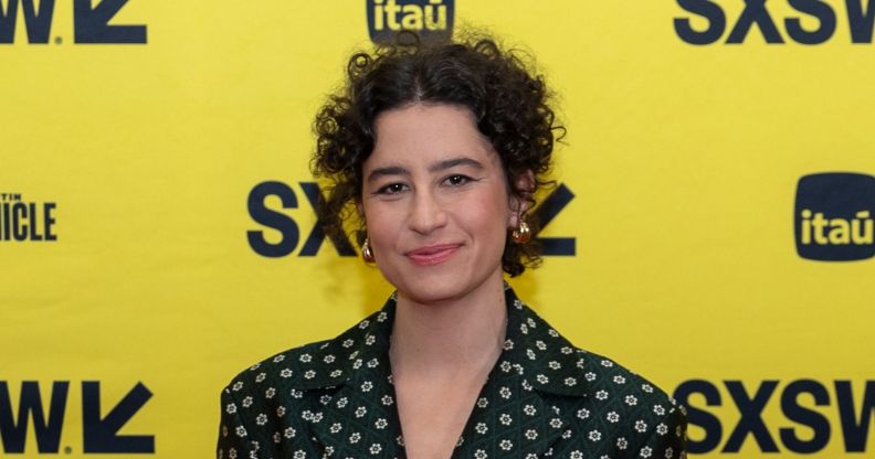 Ilana Glazer in a spotted dress against a yellow background