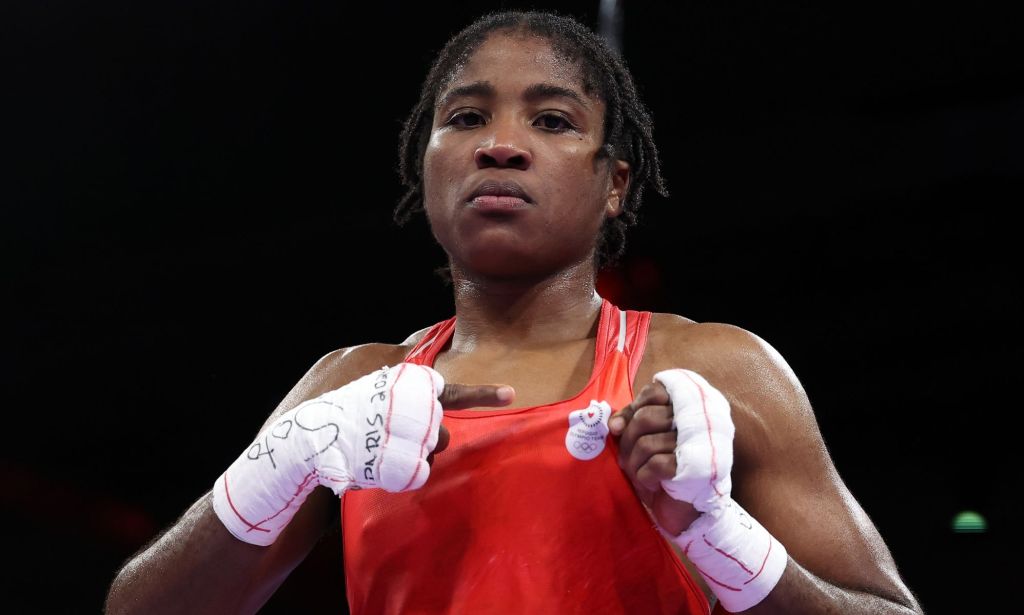 Cindy Ngamba making a fist in a Olympic ring.