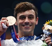 Tom Daley holds his medal