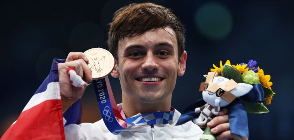 Tom Daley holds his medal