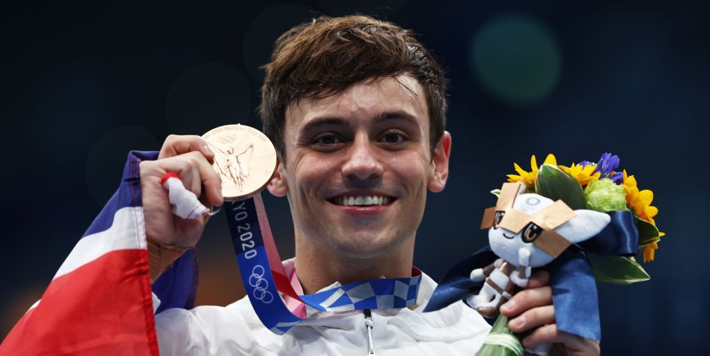 Tom Daley holds his medal