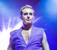 Ian H Watkins performing in a sleeveless purple waistcoat