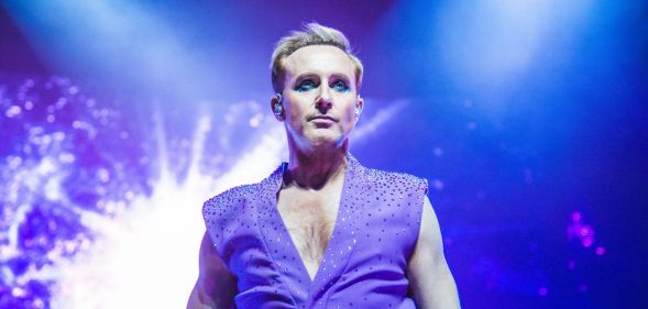 Ian H Watkins performing in a sleeveless purple waistcoat