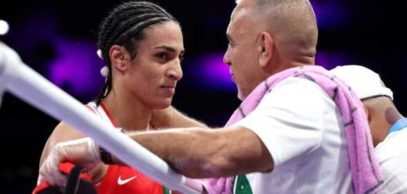 Imane Khelif of Team Algeria interacts with a coach of Team Algeria after Angela Carini of Team Italy (not pictured) abandons the Women's 66kg preliminary round match in the first round on day six of the Olympic Games Paris 2024 at North Paris Arena on 1 August, 2024 in Paris, France.