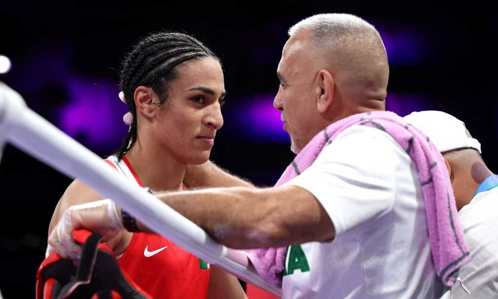 Imane Khelif of Team Algeria interacts with a coach of Team Algeria after Angela Carini of Team Italy (not pictured) abandons the Women's 66kg preliminary round match in the first round on day six of the Olympic Games Paris 2024 at North Paris Arena on 1 August, 2024 in Paris, France.