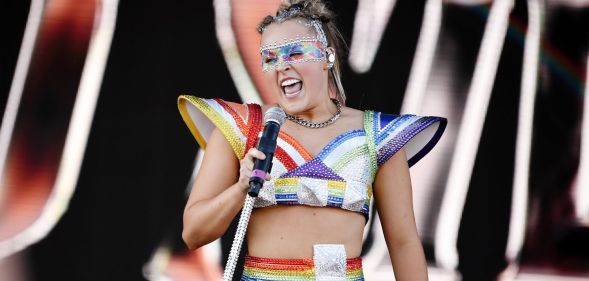 JoJo Siwa performs at a Pride event wearing rainbow-coloured outfit