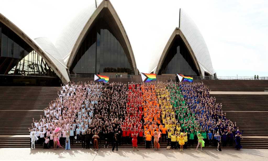 SYDNEY, AUSTRALIA - JUNE 24: 1,000 people form a human progress flag on the steps of the Opera House to mark the 44th anniversary or the Sydney Gay and Lesbian Mardis Gras Sydney Opera House on June 24, 2022 in Sydney, Australia. Australia will host WorldPride 2023. (Photo by Don Arnold/Getty Images)