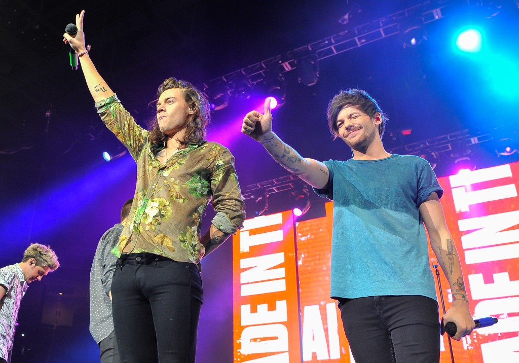 Harry Styles and Louis Tomlinson of One Direction performing