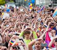 Attendees of Leipzig Pride hold up a heart symbol as they participate in the Pride rally.