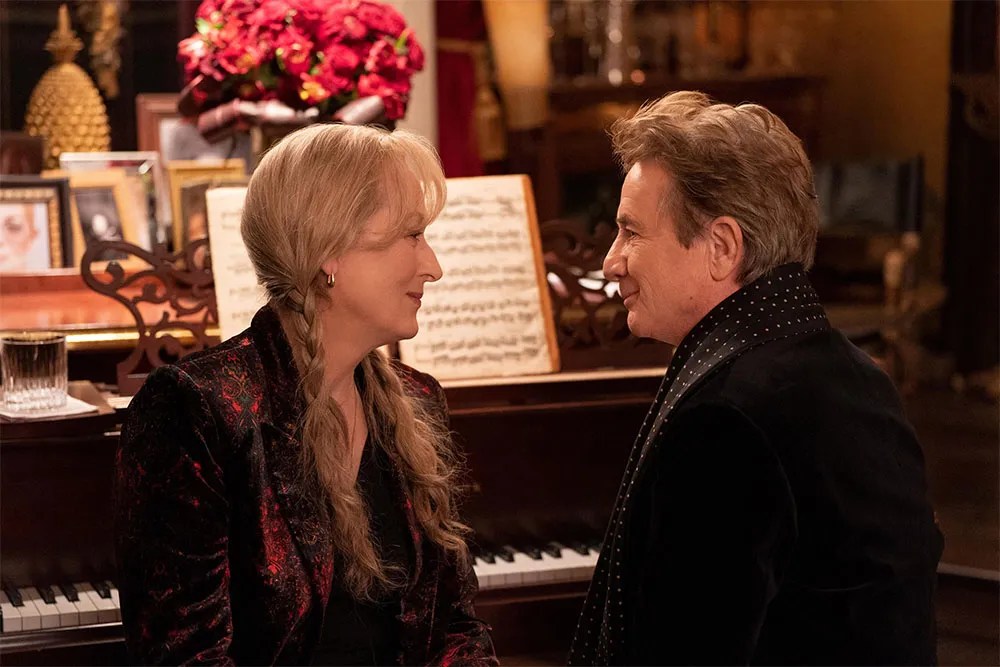 Meryl Streep and Martin Short sitting together on a piano bench.