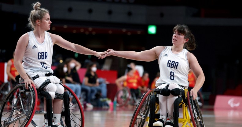 Britain's Robyn Love and her partner Laurie Williams touch hands in the wheelchair basketball women's classification playoff