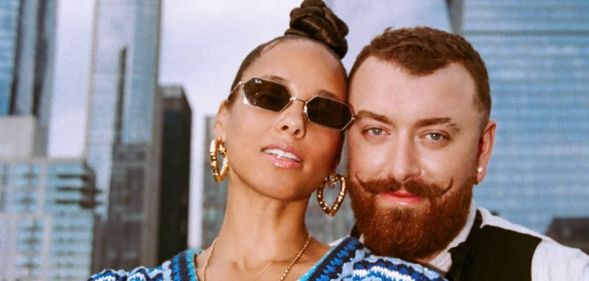 Sam Smith and Alicia Keys pose on a rooftop