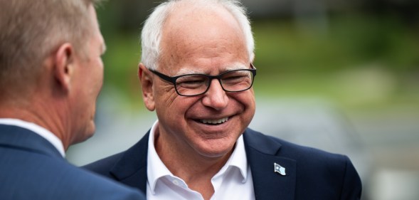 Minnesota Governor Tim Walz smiling while stood outside