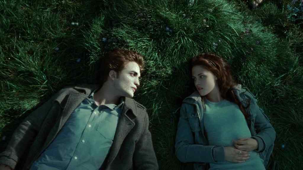 Twilight film still of Edward and Bella lying on the grass, his skin glittering