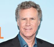 Will Ferrell smiles as he poses against a blue and orange red carpet background