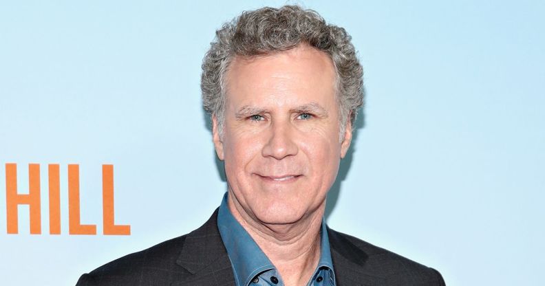 Will Ferrell smiles as he poses against a blue and orange red carpet background