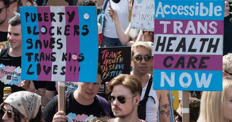 Protesters carry placards against the ban on puberty blockers and for accessible trans healthcare. (Wiktor Szymanowicz/Future Publishing via Getty Images)