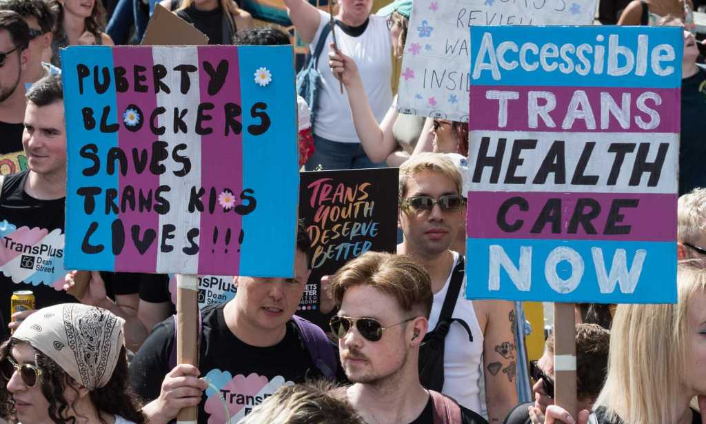 Protesters carry placards against the ban on puberty blockers and for accessible trans healthcare. (Wiktor Szymanowicz/Future Publishing via Getty Images)