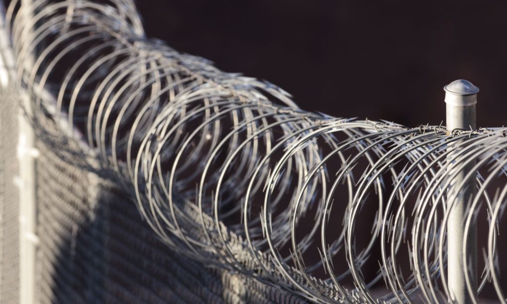 The barbed wire of an asylum detention centre. 